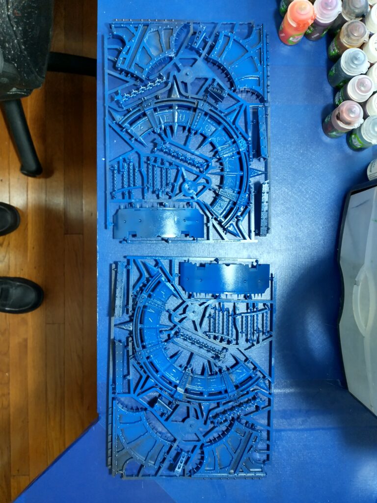 Black-primed terrain pieces with blue over-spray and a light silver spray