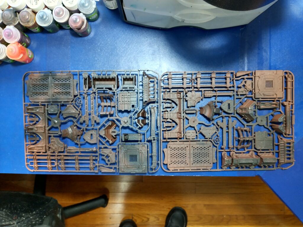 Brown-primed terrain sprues with black streaking