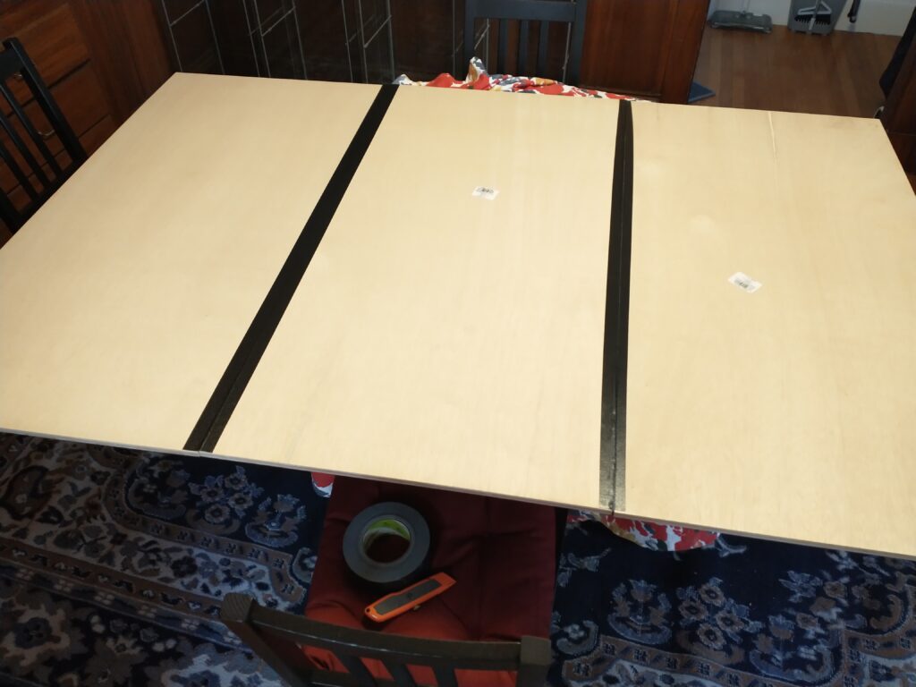 Three boards laid out with the second hinge begun.