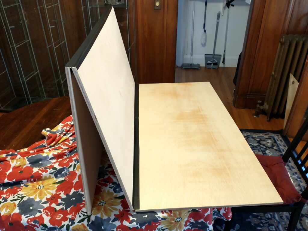 A picture showing two boards folded up and the third connected to them