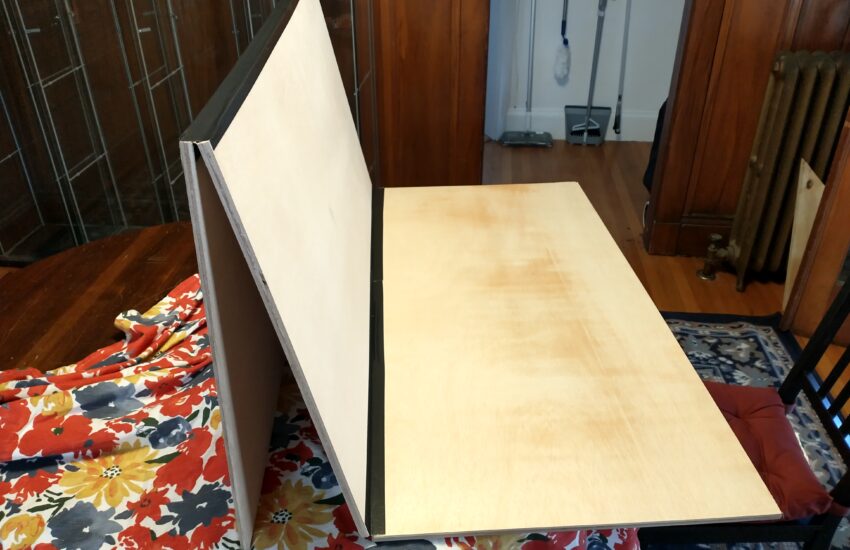 A picture showing two boards folded up and the third connected to them
